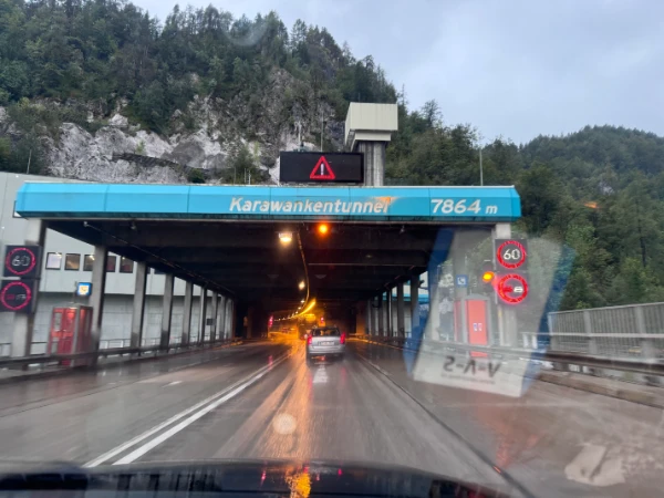 Entering the Karawankentunnel (7864m) on the Austrian-Slovenian border with 60 km/h speed limit and warning signs, captured on September 12, 2024