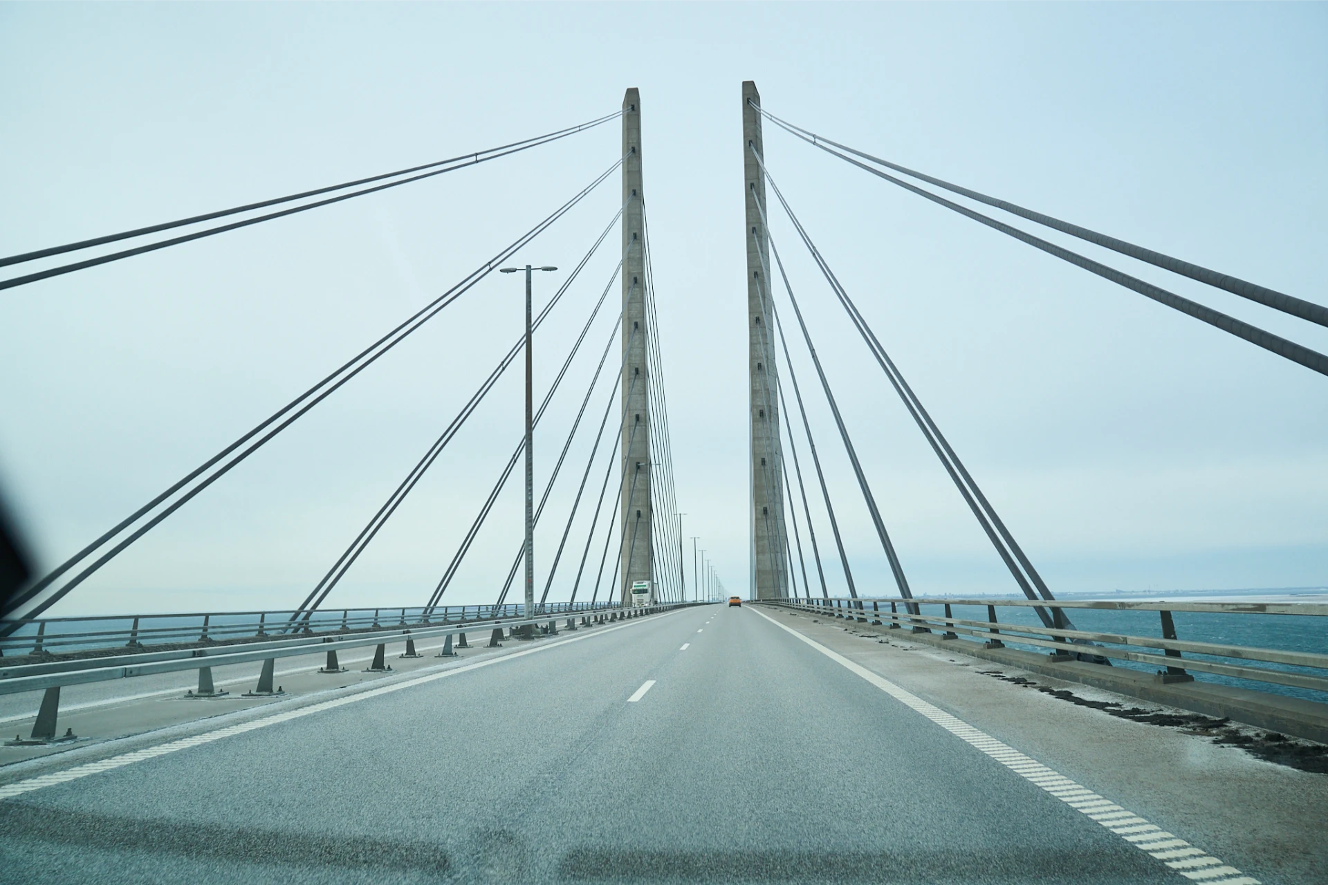 Driving across the Øresund Bridge between Denmark and Sweden, view of the cable-stayed pylons and open road over the Øresund strait, captured on February 6, 2026