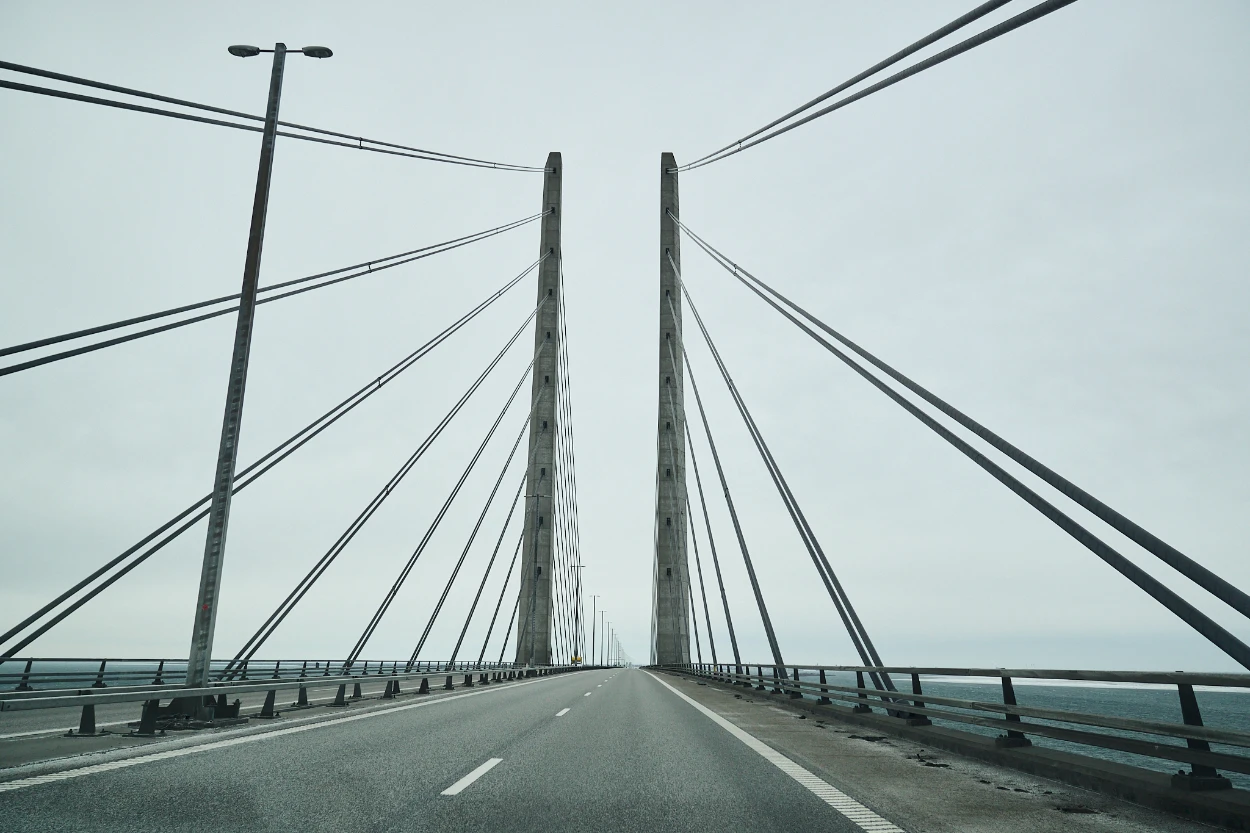 Driving between the Øresund Bridge cable-stayed pylons over the Øresund strait on an overcast day, captured on February 6, 2026