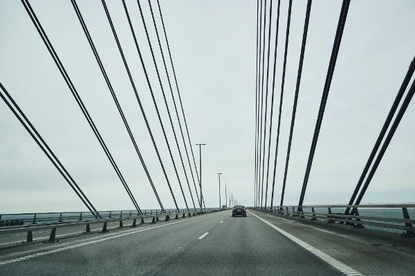 Test driving across the Øresund Bridge on February 6, 2026, view of the cable stays and open roadway over the Øresund strait with a car ahead